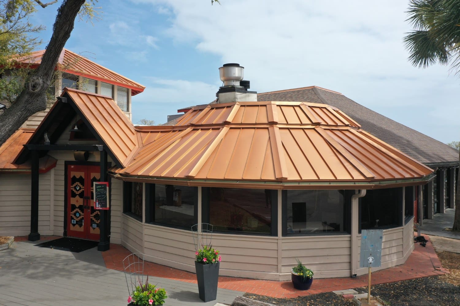 A building with a roof that has a fire hydrant on it.