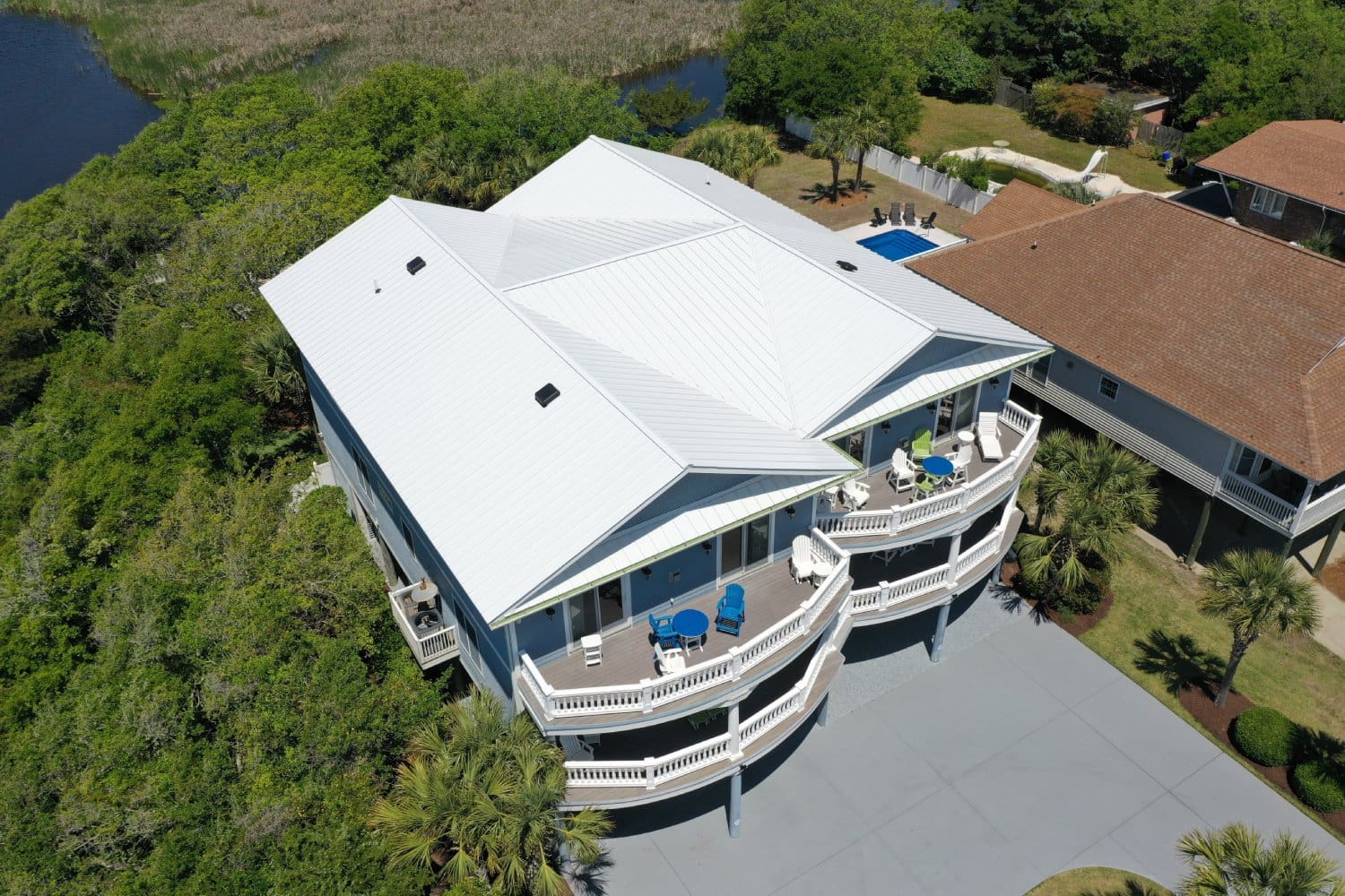 A large white house with a pool in the middle of it.