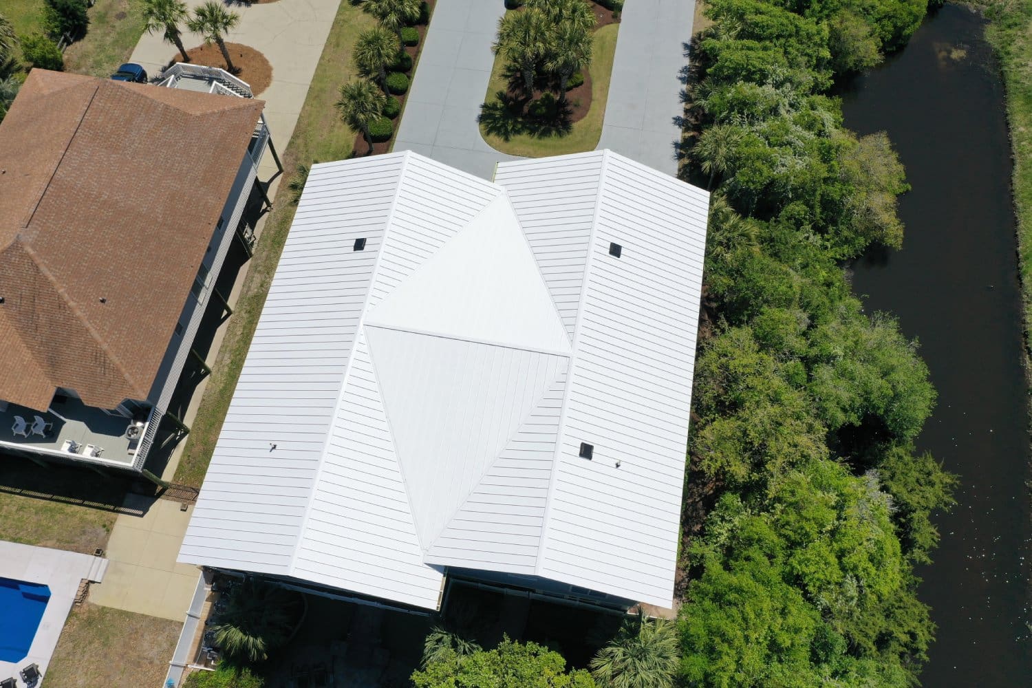 A white roof with trees in the background