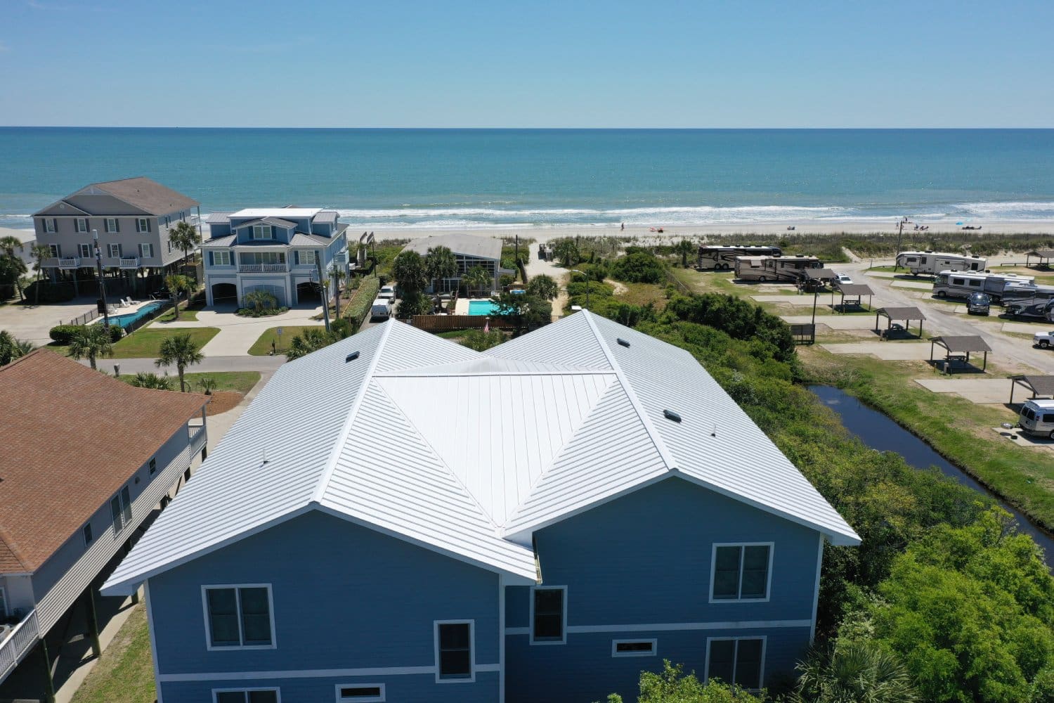 A house with a view of the ocean and beach.