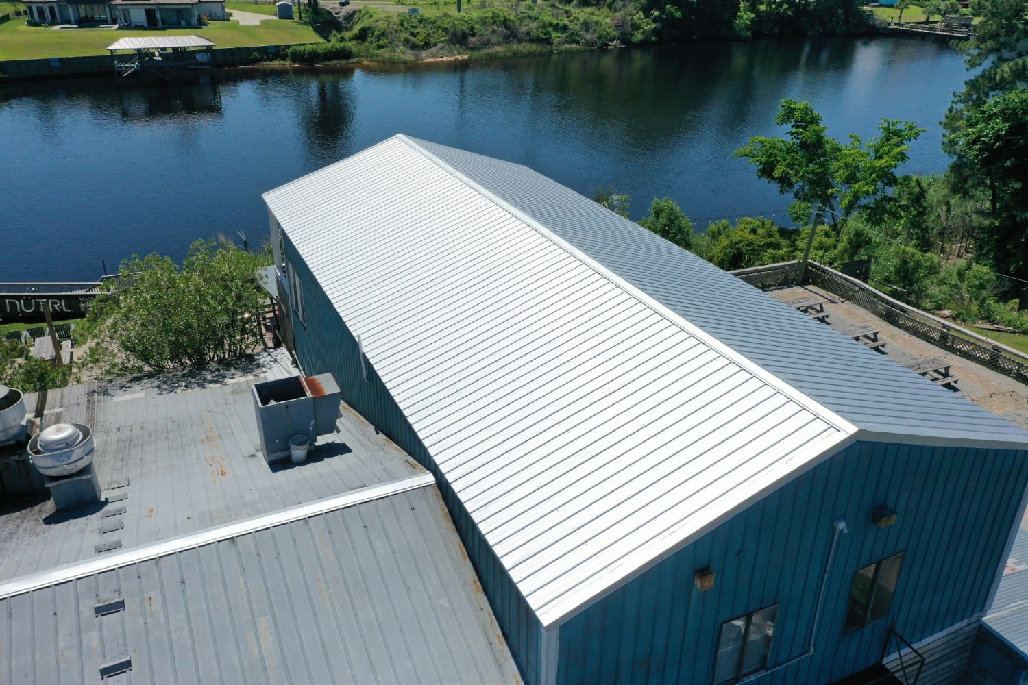 A large white building next to the water.