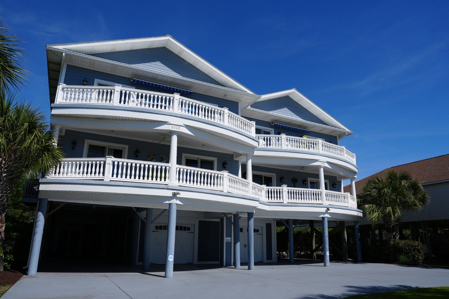 A large white building with balconies and a balcony.